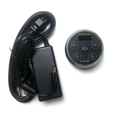 The Critical Atom X Power Supply with a magnetic base and the power adaptor cord. 