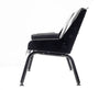 Side view of the black Comfort Before Pain Waiting Room Bench for tattoo shops highlighting the bench's metal frame. 
