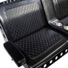 A seat of a black vinyl Comfort Before Pain Waiting Room Bench by TATSoul.  