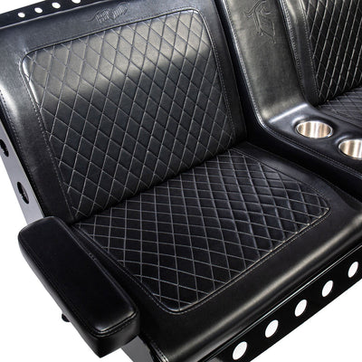 A seat of a black vinyl Comfort Before Pain Waiting Room Bench by TATSoul.  